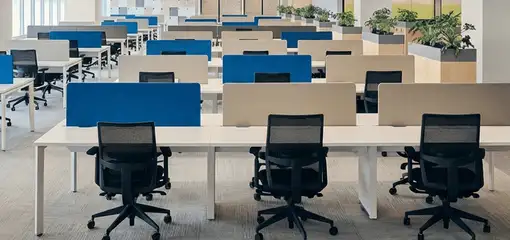 Modern open-plan office space featuring clean workstations, ergonomic chairs, and sanitized carpets provided by professional office cleaning services in Naperville, IL.