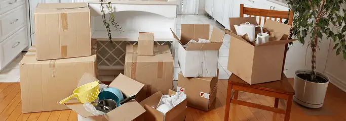 Packed moving boxes and household items in a kitchen before move-out or move-in cleaning, Naperville, IL.